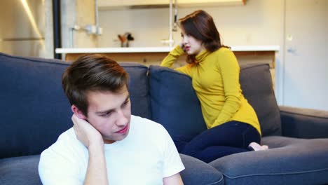 Woman-ignoring-man-while-argument-in-living-room