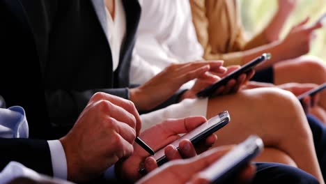 Business-executives-using-mobile-phone