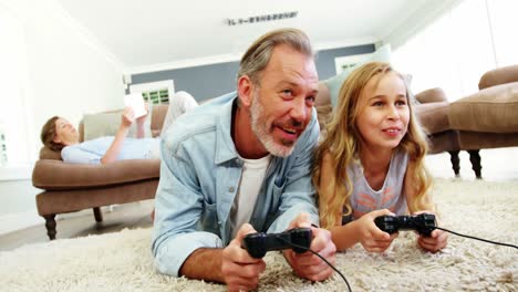 Father-and-daughter-playing-video-game-in-living-room