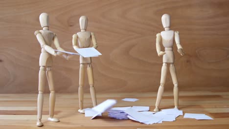 Business-figurine-standing-near-pile-of-documents-falling-from-top
