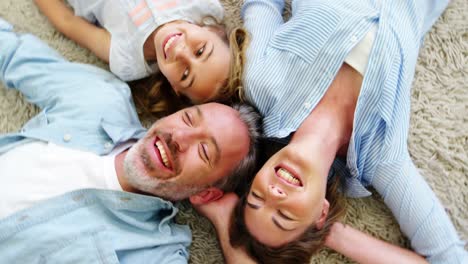 Happy-family-in-lying-on-rug-in-living-room