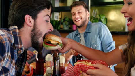 Woman-feeding-burger-to-man-