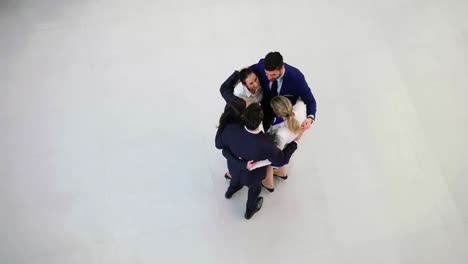 Team-of-businesspeople-forming-huddle