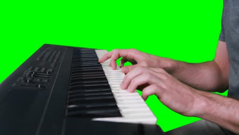 Mid-section-of-musician-playing-electronic-piano