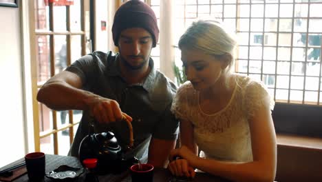 Couple-interacting-with-each-other-while-having-tea