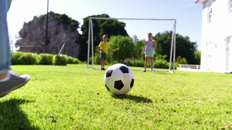 Father-and-kids-playing-football
