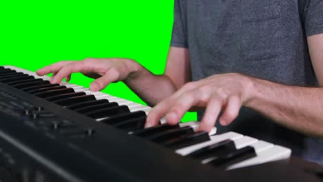 Mid-section-of-musician-playing-electronic-piano