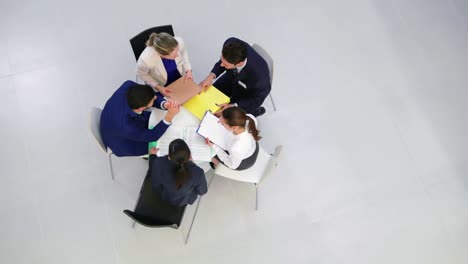 Businesspeople-discussing-during-meeting-in-office