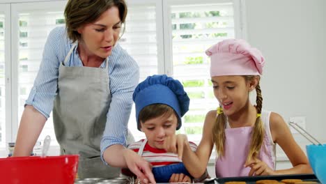 Mother-and-children-making-cookies-in-kitchen