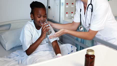 Female-doctor-giving-medicine-to-sick-girl