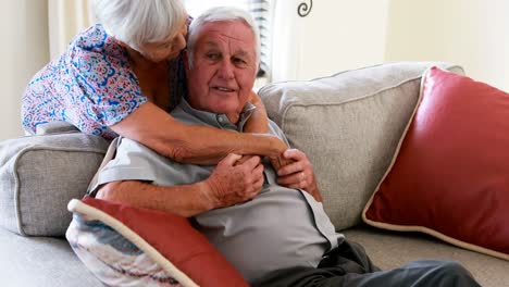 Senior-couple-embracing-each-other-in-living-room