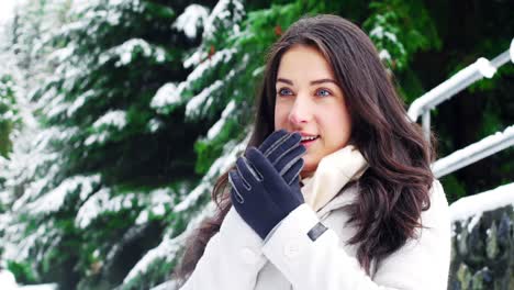 Woman-in-warm-clothing-warming-her-hands