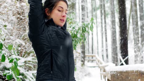 Beautiful-woman-exercising-during-snowfall