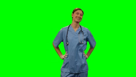 Happy-female-surgeon-standing-against-green-screen