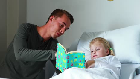 Girl-on-bed-reading-book-with-her-father