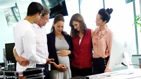 Executives-interacting-with-pregnant-woman