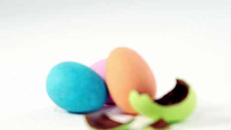 Broken-chocolate-Easter-egg-against-three-chocolate-Easter-eggs