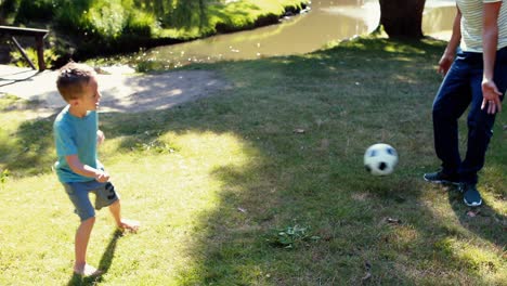 Vater-Und-Sohn-Spielen-Mit-Einem-Fußball-Im-Park