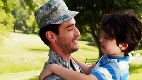 Army-soldier-interacting-with-his-son-in-park