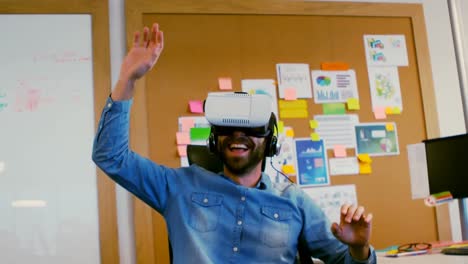 Smiling-executive-using-virtual-reality-headset