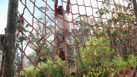 Military-soldier-climbing-rope-during-obstacle-course