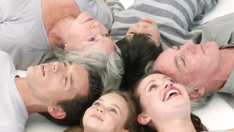 Happy-family-lying-on-floor-with-heads-together