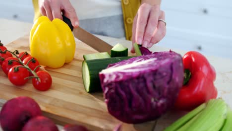 Woman-chopping-vegetables-in-the-kitchen-at-home