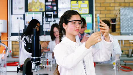 Portrait-of-schoolgirl-doing-a-chemical-experiment-in-laboratory