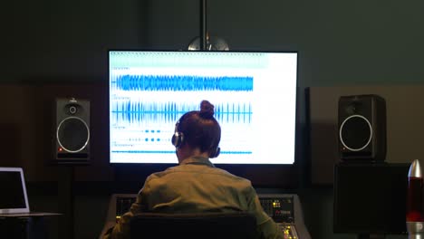 Male-audio-engineer-using-sound-mixer
