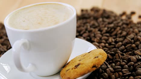 Coffee-with-cookie-on-roasted-beans