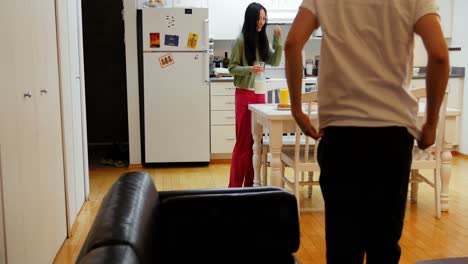 Woman-serving-breakfast-to-man-in-kitchen
