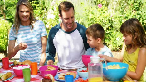 Family-having-meal-in-house-garden