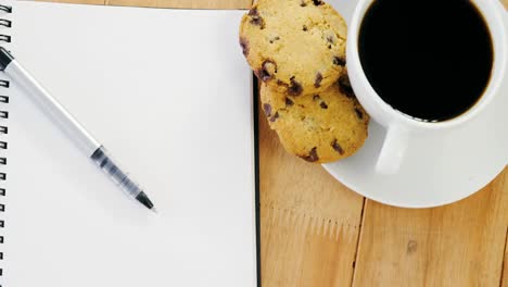 Open-diary-with-pen-and-black-coffee
