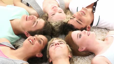 Teenagers-with-their-heads-together-on-the-ground-