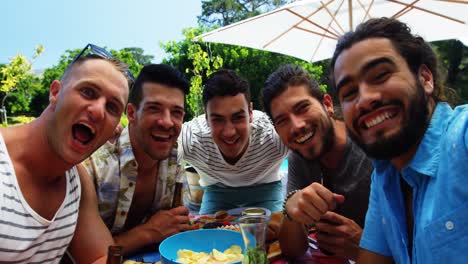 Group-of-happy-friends-having-fun-together-at-outdoors-barbecue-party