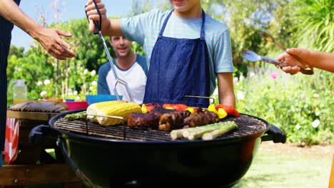 Kids-grilling-meat-and-vegetables-on-barbecue