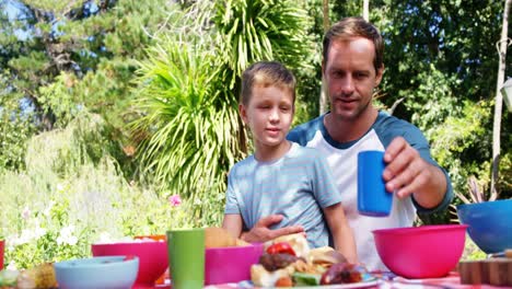 Father-and-son-having-meal-in-the-garden-house