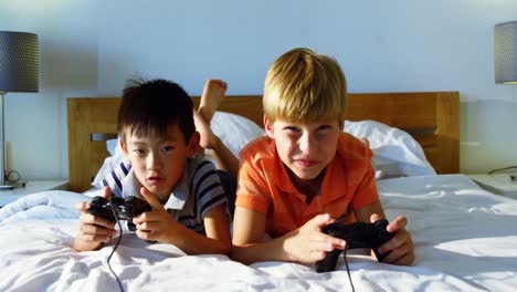 Siblings-playing-video-game-in-bedroom