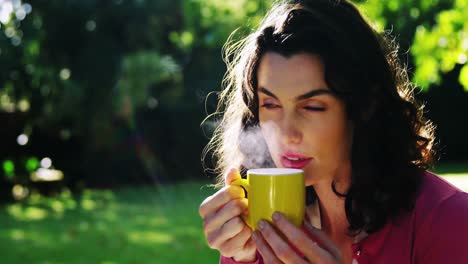 Beautiful-woman-drinking-coffee-in-garden