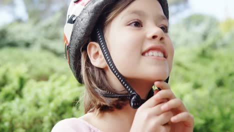 Smiling-girl-wearing-helmet-in-the-park