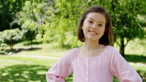Smiling-girl-standing-in-the-park