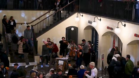 Playing-music-before-Christmas-here-in-Covent-Garden,-London,-United-Kingdom