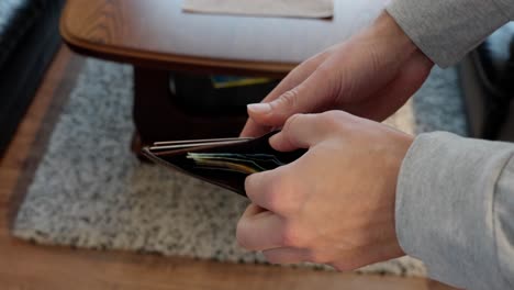 Man-takes-Norwegian-money-out-from-wallet-and-count-them-in-hand,-close-up