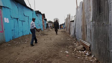 Gente-Caminando-Por-Un-Sendero-Estrecho-En-Un-Barrio-Pobre