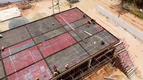 Aerial-view-of-building-under-construction-of-photovoltaic-power-plant-with-workers-on-top