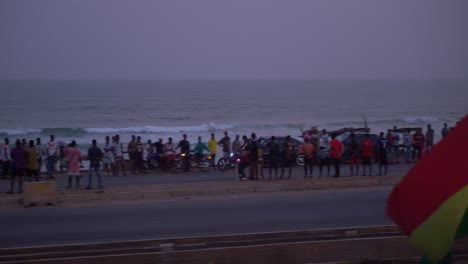 male-black-african-riding-motorcycle-in-acrobatic-style-performing-near-the-beach