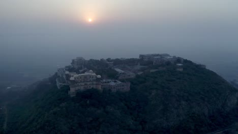 Aerial-drone-view-where-many-castles-are-visible-on-the-hill-and-there-are-mountains-around