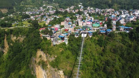 Aerial-approaching-shot-of-bridge-and-Pokhara-City-on-mountain-during-sunny-day-in-Nepal