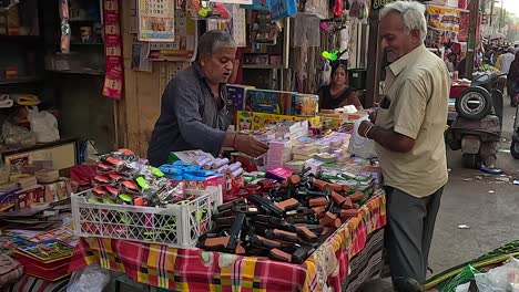 A-shopkeeper-is-explaining-to-a-customer-in-a-toy-shop-how-to-use-a-toy