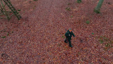 A-hunter-in-thick-winter-clothing-walks-away-from-a-hunting-stand